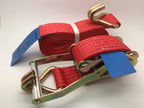 Red ratchet straps tie down with metal hooks and a sturdy ratchet mechanism for secure load fastening